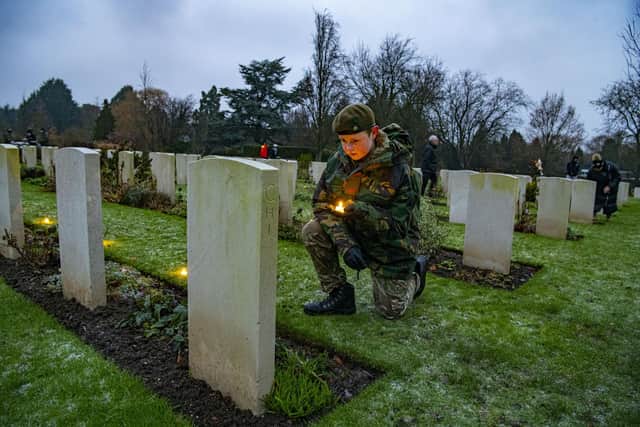 Army cadet Eden Grundy lays a candle at a fallen Canadian grave at the Candlelit Christmas Remembrance event held at the Commonwealth War Graves Commission's (CWGC) Stonefall Cemetery in Harrogate. Picture Tony Johnson