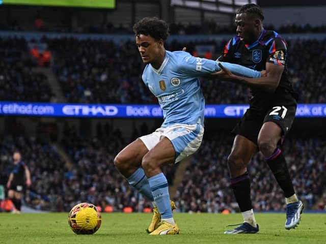 RELENTLESS ENERGY: Huddersfield Town' loanee Alex Matos (right) gets to grips with Manchester City's Oscar Bobb