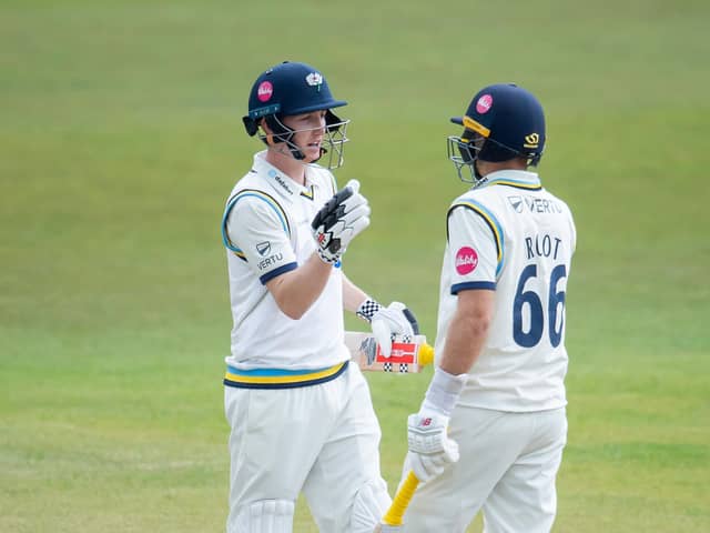 Well played, partner: Harry Brook, left, celebrates his century with Joe Root at Headingley on Saturday. Brook hit 126 not out and Root 119 as Yorkshire chase their first win of the season. Picture by Allan McKenzie/SWpix.com
