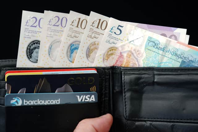 Notes and credit cards in a wallet. PIC: Peter Byrne/PA Wire
