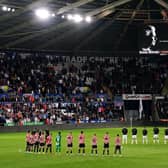 Swansea City and Sheffield United players, officials and fans observe a minutes silence in memory of Queen Elizabeth II, who died on Thursday September 8, ahead of the Sky Bet Championship match at the Swansea.com Stadium, Swansea. (Picture: PA)