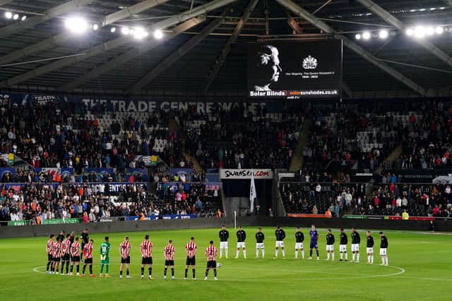 Swansea City and Sheffield United players, officials and fans observe a minutes silence in memory of Queen Elizabeth II, who died on Thursday September 8, ahead of the Sky Bet Championship match at the Swansea.com Stadium, Swansea. (Picture: PA)