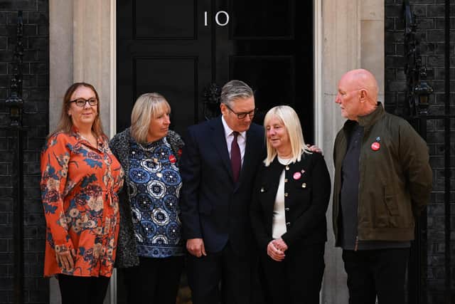 Britain's Prime Minister Keir Starmer (C) poses with Charlotte Hennessy (L), Sue Roberts (2L), Margaret Aspinall (2R), and Steve Kelly, representing family members, survivors and campaigners for the victims of the Hillsborough Disaster, on the steps of 10 Downing Street in London on September 16, 2025. UK Prime Minister Starmer met with some of the Hillsborough families as the Government introduces the Public Office (Accountability) Bill, to be known as the Hillsborough Law. (Photo by Leon Neal / POOL / AFP) (Photo by LEON NEAL/POOL/AFP via Getty Images)