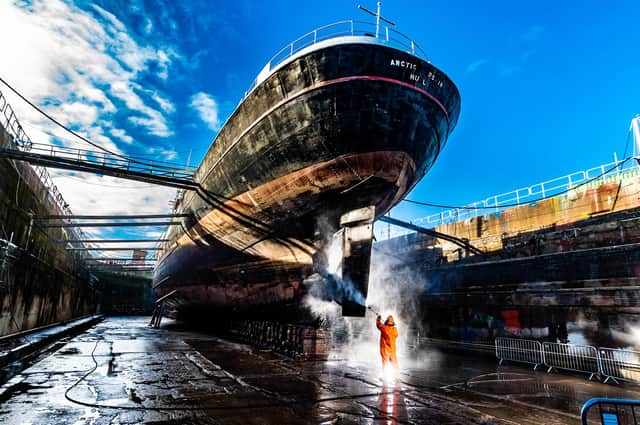 Ken Knaggs, Water blaster and painter for Dunston's Ship Repairs Ltd based in Hull power washing the hull of the Arctic Corsair whilst she is in dry dock.
