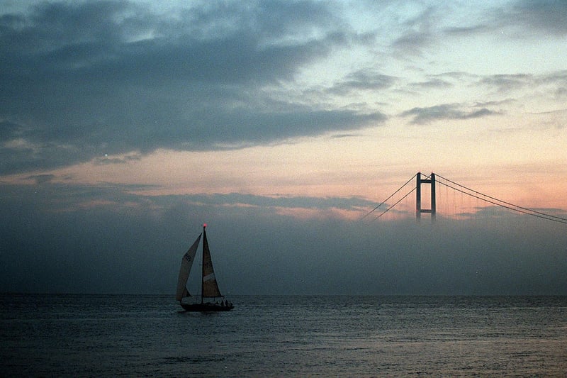 A yacht makes its way down the River Humber as a late autumn fog bank shrouds the lower half of the Humber Bridge in November 1996.