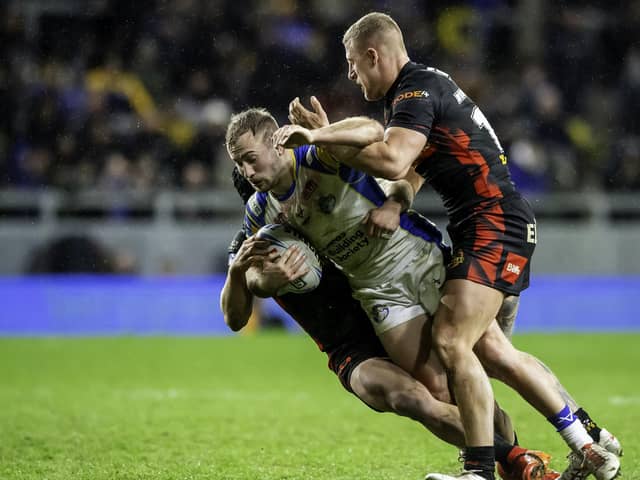 Leeds' Jarrod O'Connor is tackled by St Helens. (Picture: SWPix.com)