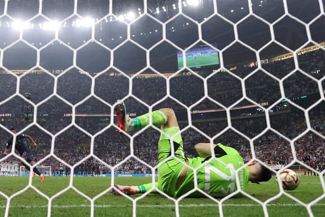 Emiliano Martinez of Argentina saves the second penalty from Kingsley Coman of France in the penalty shoot out  during the FIFA World Cup Qatar 2022 Final match between Argentina and France. (Picture: Julian Finney/Getty Images)