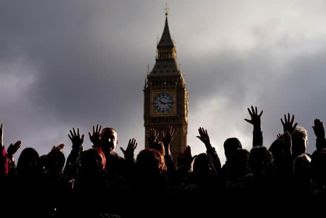 People take part in a vigil organised by Medical Aid for Palestinians at Parliament Square. PIC: Aaron Chown/PA Wire