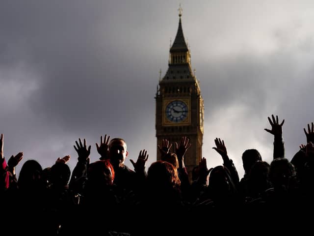 People take part in a vigil organised by Medical Aid for Palestinians at Parliament Square. PIC: Aaron Chown/PA Wire