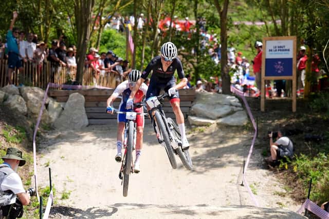 OVER THE TOP: Tom Pidcock drives from the front during yesterday's Cross-country mountain bike at Elancourt Hill - eventually clinching a second gold medal following his success in Tokyo three years ago. Picture: Martin Rickett/PA