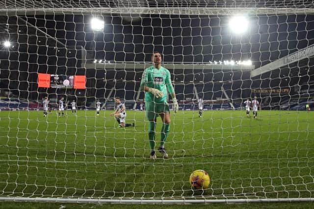 DESPAIR: West Bromwich Albion goalkeeper Sam Johnston retrieves the ball after Leeds United score their fourth goal at The Hawthorns