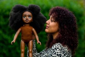 Picture James Hardisty.
Olivia , of Leeds,  with one of her Akila Dolls.
