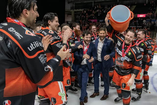TASTE OF SUCCESS: Sheffield Steelers' captain Robert Dowd (far right) celebrates with his team-mates and coaches Carter Beston-Will and Aaron Fox after beating Guildford Flames 3-1 in the 2024 Challenge Cup Final at the Utilita Arena on Wednesday. Picture: Tony Johnson.