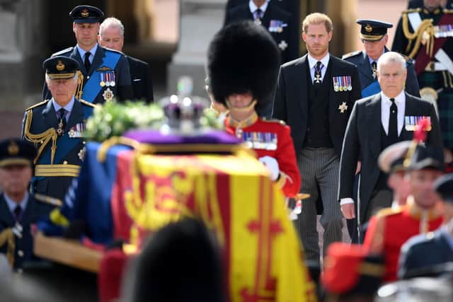King Charles III, the Prince of Wales and the Duke of Sussex follow the coffin of Queen Elizabeth II, draped in the Royal Standard with the Imperial State Crown placed on top, as it is carried on a horse-drawn gun carriage of the King's Troop Royal Horse Artillery, during the ceremonial procession from Buckingham Palace to Westminster Hall, London, where it will lie in state ahead of her funeral on Monday. Picture date: Wednesday September 14, 2022. PA Photo. See PA story DEATH Queen. Photo credit should read: Daniel Leal/PA Wire