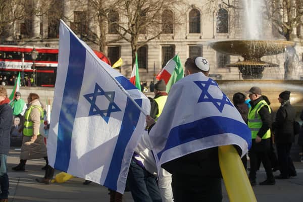 People with flags during a pro-Israel rally in Trafalgar Square. PIC: Jeff Moore/PA Wire