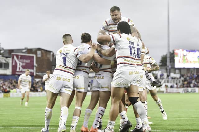 Wakefield's Lee Kershaw is congratulated by team mates on scoring a try against Salford. (Photo: Matthew Merrick/SWpix.com)