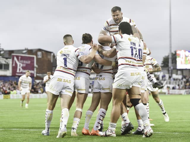 Wakefield's Lee Kershaw is congratulated by team mates on scoring a try against Salford. (Photo: Matthew Merrick/SWpix.com)