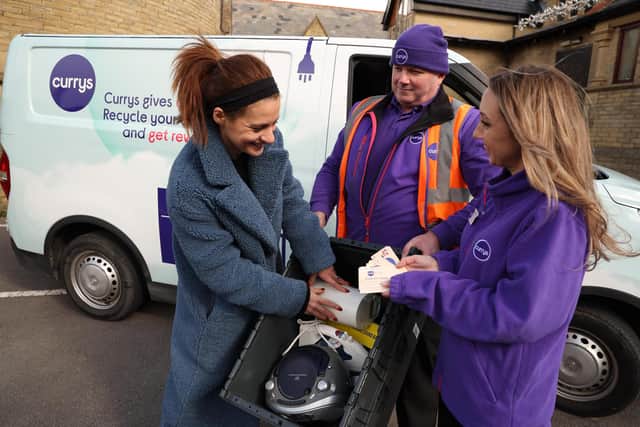 (Left to right) Bradford local Cleo Mcgee with Duncan Farrant and Izzy Williams from Currys collect old and unwanted tech from households in Bradford as part of ‘Currys Collect’ a new pilot door-to-door tech recycling service to raise awareness of e-waste. Picture: Nigel Roddis/PA Wire.