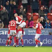 IMPRESSIVE: Rotherham United players leap on Ollie Rathbone after he scored their second goal