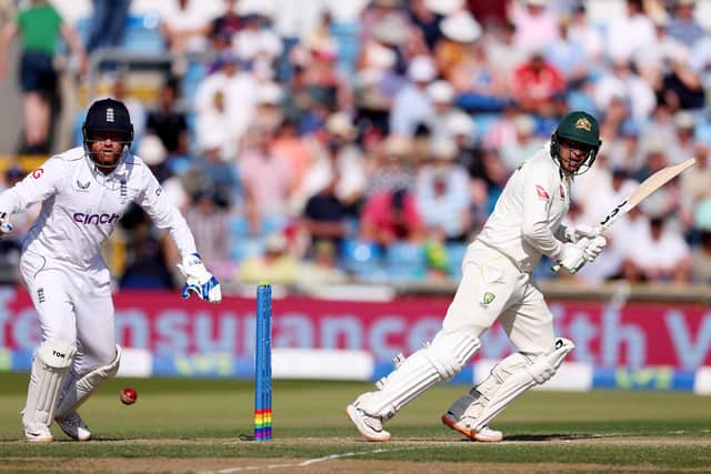 Usman Khawaja turns the ball away watched by England's Jonny Bairstow. Photo by Richard Heathcote/Getty Images.