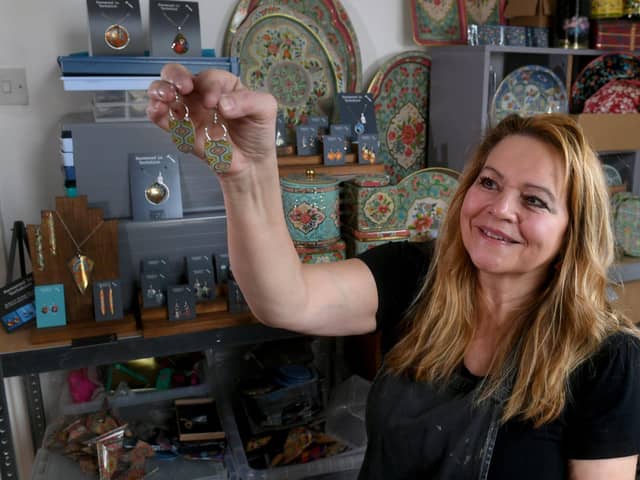 Nancy Jones creates beautiful drop earrings and pendants from vintage tins pictured in her studio at Thornton Village, Bradford Picture taken by Yorkshire Post Photographer Simon Hulme