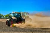 Farmers drive their tractors through a dry and dusty field near Helmsley, North Yorkshire in 2025. Picture: James Hardisty.