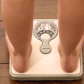 Someone using a set of weighing scales. PIC: Chris Radburn/PA Wire