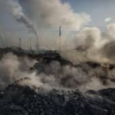 Steam and smoke from waste coal and stone rises after being dumped next to an unauthorized steel factory on November 3, 2016 in Inner Mongolia, China. PIC: Kevin Frayer/Getty Images