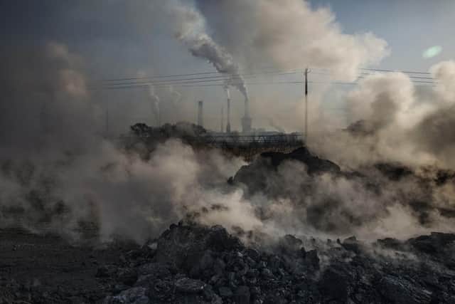 Steam and smoke from waste coal and stone rises after being dumped next to an unauthorized steel factory on November 3, 2016 in Inner Mongolia, China. PIC: Kevin Frayer/Getty Images