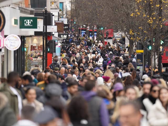 People shopping on Oxford Street in London. Christmas shoppers provided retail and hospitality with a crucial boost despite the cost-of-living crisis and rail strikes, figures show.