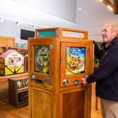 Auctioneer Andy Spicer looking at a hexagonal Allwin arcade machine, by O. Whales, Fun City Redcar, c.1955, containing five machines, Olwin Beach Ball, Olwin Skill Cup, 2 x Have a Go and one other, 92 x 169cm, 2p play.Provenance; Watermouth Castle, Ilfracombe, North Devon.
Picture By Yorkshire Post Photographer,  James Hardisty. Date: 15th November 2023.