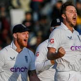 England's Ollie Robinson (2R) celebrates teammate after taking the wicket of Pakistan's Salman Ali Agha (not pictured) during the fifth and final day of the first cricket Test match between Pakistan and England at the Rawalpindi Cricket Stadium (Picture: AAMIR QURESHI/AFP via Getty Images)