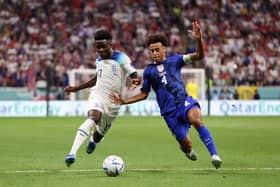 AL KHOR, QATAR - NOVEMBER 25: Bukayo Saka of England is tackled by Tyler Adams of United States during the FIFA World Cup Qatar 2022 Group B match between England and USA at Al Bayt Stadium on November 25, 2022 in Al Khor, Qatar. (Photo by Ryan Pierse/Getty Images)
