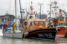 A yacht safely arrives back in Bridlington harbour with the Bridlington all-weather lifeboat.