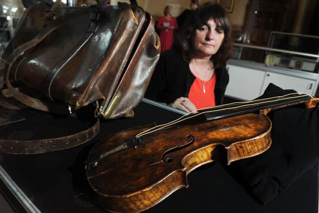 The violin played by RMS Titanic bandmaster and Dewsbury resident, Wallace Hartley on its return to Dewsbury for the first time in more than 100 years. Pictured is Nicola Colloby, who now lives in Hartley's old home, in October 2013. Picture by Bruce Rollinson.