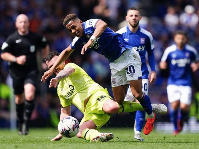BATTLING: Ipswich Town's Omari Hutchinson is fouled by Huddersfield Town's Tom Edwards at Portman Road Picture: Zac Goodwin/PA