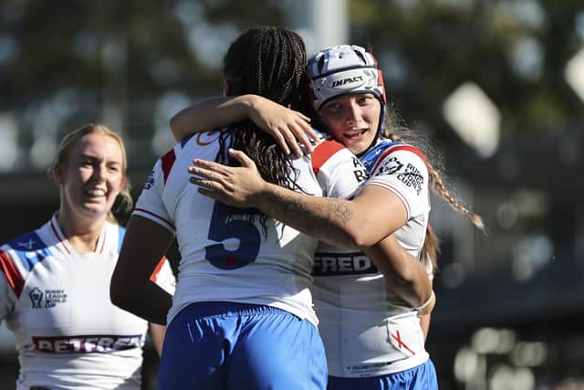Amelia Brown is congratulated after going the length of the field in the opening game. (Photo: Anita Reca/SWpix.com)