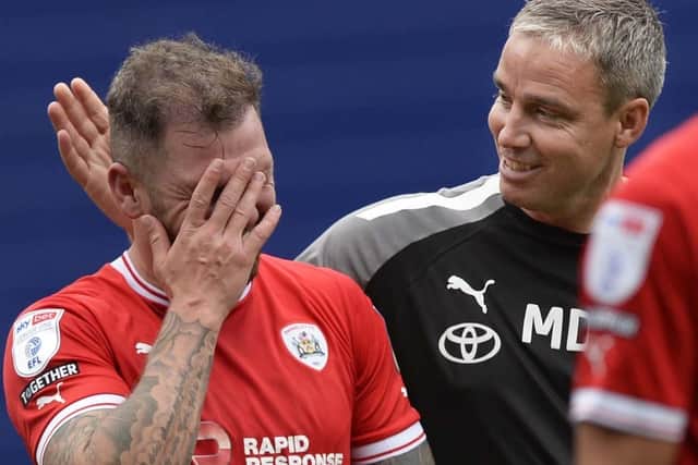 Barnsley manager Michael Duff congratulates scorer James Norwood at the final whistle. Picture: Steve Ellis