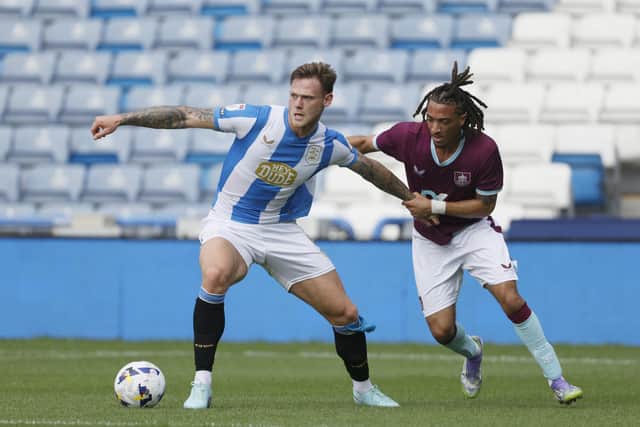 Huddersfield Town's Joe Low (left) battles for the ball with Burnley's Luca Koleosho during the pre-season friendly match at Accu Stadium, Huddersfield. Picture: Richard Sellers/PA Wire.