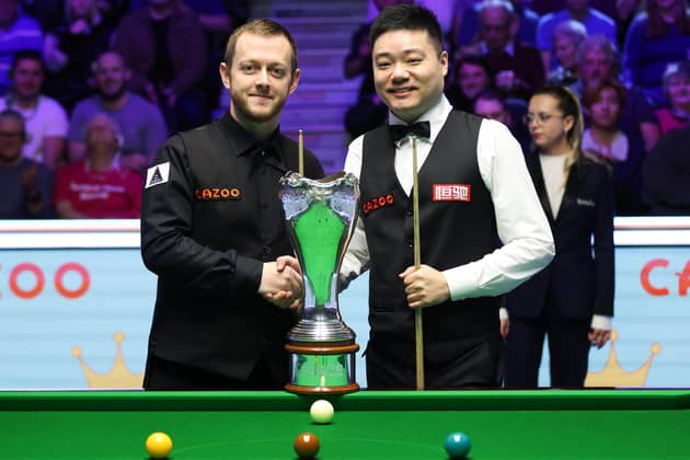 Northern Ireland’s Mark Allen (left) shakes hands with China’s Ding Junhui during day nine of the Cazoo UK Snooker Championship at the York Barbican in 2022.