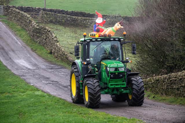 Andrew Walker (right) and his brother Ben,  along with the Lothersdale Agricultural Discussion Group came up with RUDOLPH’S RUN a new festive tractor run last year - aimed solely at raising money for charities for Manorlands Hospice & Airedale Hospital - they raised over £6,000, had 50 tractors in the run.
Ben and Andrew dress one of their tractors.