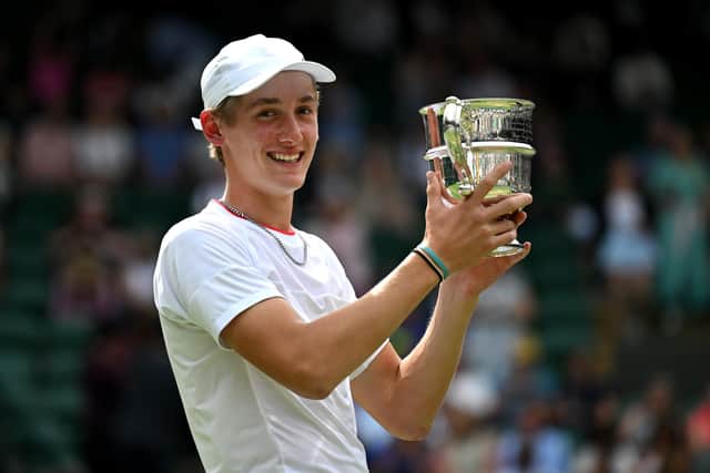 Henry Searle of Great Britain lifts the Boy's Singles Trophy following victory in the Boy's Singles Final against Yaroslav Demin at Wimbledon (Picture: Shaun Botterill/Getty Images)