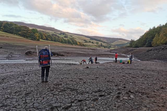 Members of Edale Mountain Rescue are pictured helping a stricken walker from the mud at Ladybower reservoir. Pictures: Edale Mountain Rescue