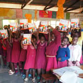 Children at Katiyo Primary School with thier new textbooks.