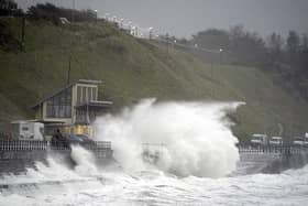 Waves crash over the promenade in Scarborough, as Storm Babet batters the country. Photo credit: Danny Lawson/PA Wire