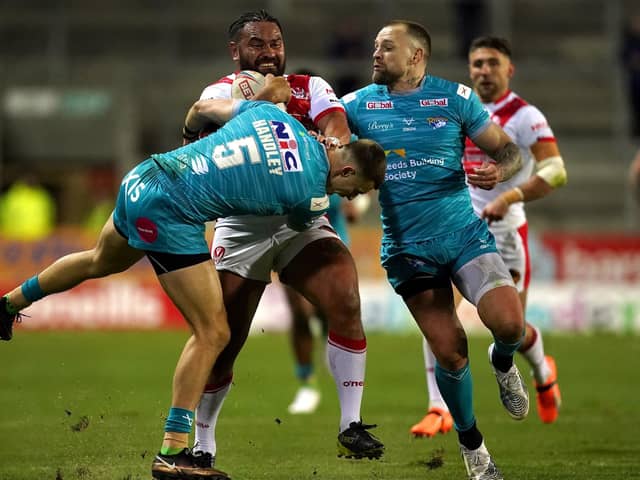 St. Helens' Konrad Hurrell is tackled by Leeds Rhinos' Ash Handley (left) and Blake Austin (Picture: Martin Rickett/PA Wire)