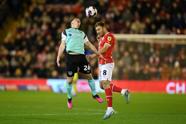 BARNSLEY, ENGLAND - MARCH 07: Tom Lowery of Portsmouth jumps for the ball with with Herbie Kane of Barnsley during the Sky Bet League One between Barnsley and Portsmouth at Oakwell Stadium on March 07, 2023 in Barnsley, England. (Photo by Michael Regan/Getty Images)