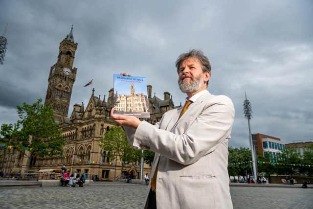 Author Dr Simon Ross Valentine, holding his book celebrating 150 years of Bradford City Hall. Picture By Yorkshire Post Photographer,  James Hardisty.