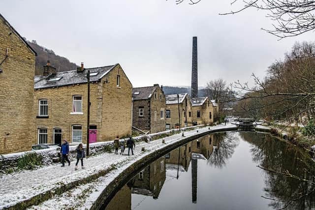 Walkers on the towpath beside the Rochdale Canal in Hebden Bridge as snow hit the region on Thursday (Feb 8).