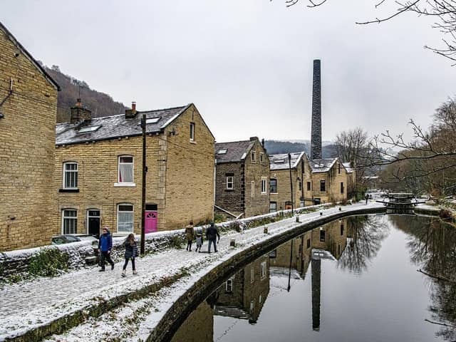 Walkers on the towpath beside the Rochdale Canal in Hebden Bridge as snow hit the region on Thursday (Feb 8).